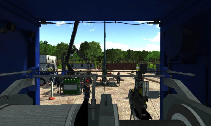 View from inside industrial equipment looking out to a construction site with machinery, vehicles, and trees in the background on a clear day.