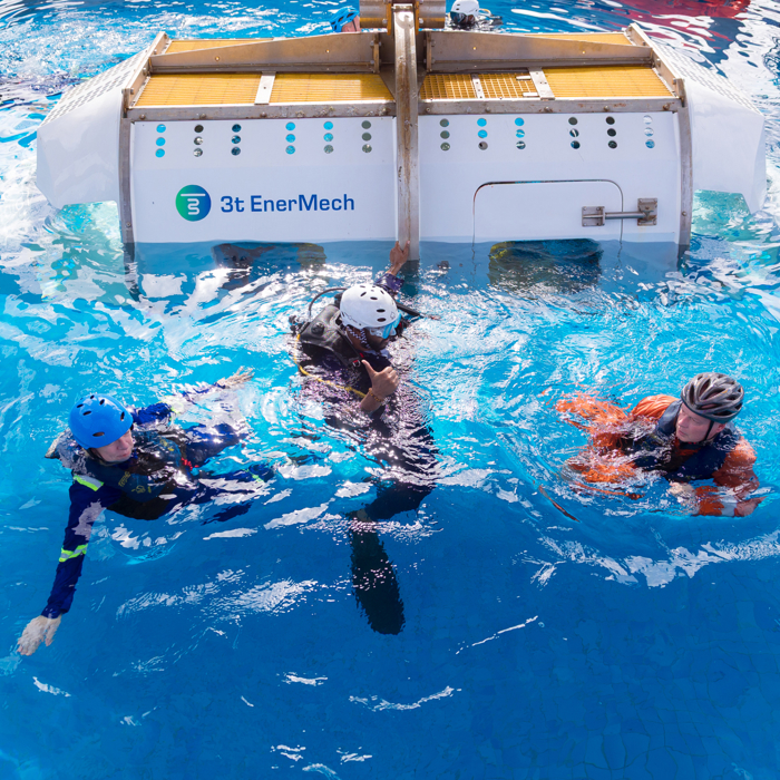 4 people in swimming pool having escaped from survival helicopter training