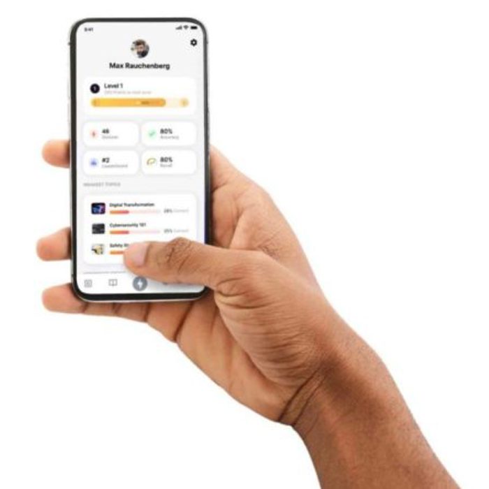 A hand holding a smartphone displaying a profile screen with user information, level progress, and various app statistics.