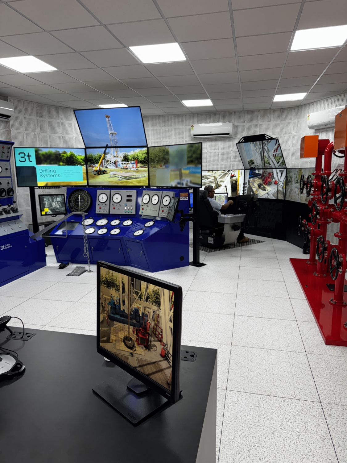 Image showing several oil and gad drilling simulator screens and training equipment