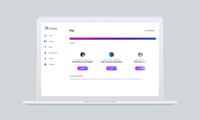 A laptop displaying a digital platform with various menu tabs on the left and training modules on the screen, including Anti-Bribery & Corruption, Cyber Security Awareness, and DEI Awareness.