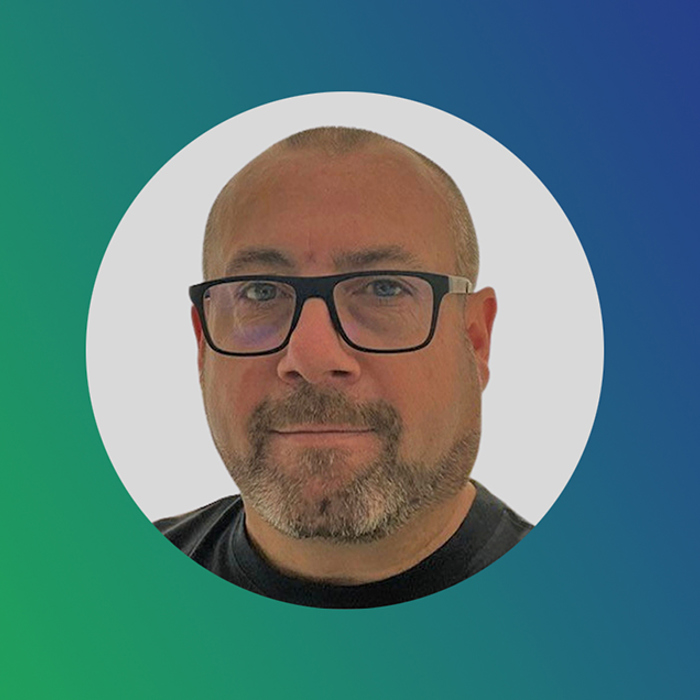 A person with glasses, a beard, and a short haircut is shown within a circular frame on a gradient green and blue background.